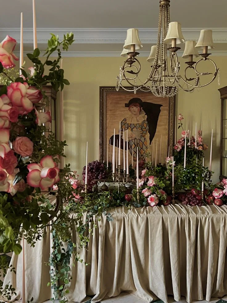 Romantic tablescape with roses, candles and chandelier lighting
