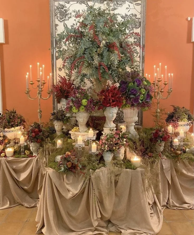 Decorative styling vignette with florals, candlelight and classical busts